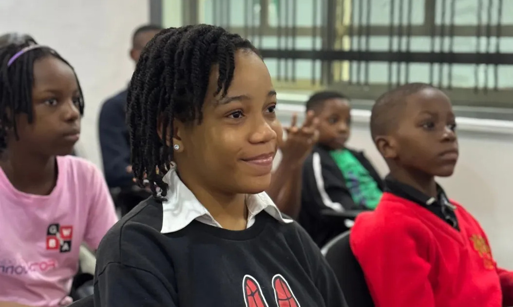 Smiling African American child studying online